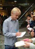 Tom signing autographs