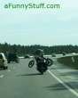 a guy carrying a harley on a harley lol
