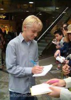 Tom signing autographs